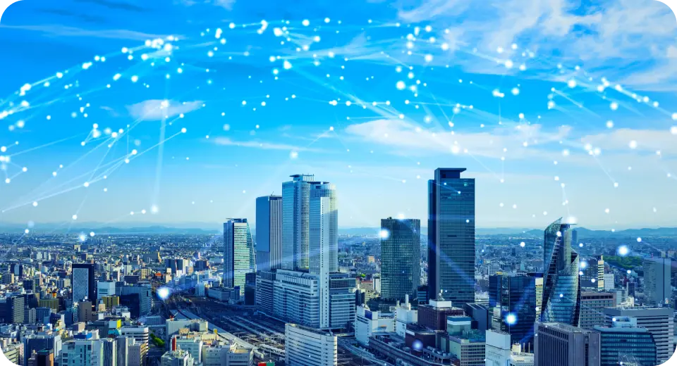 ネットワーク網が広がる都市の高層ビル群と青空