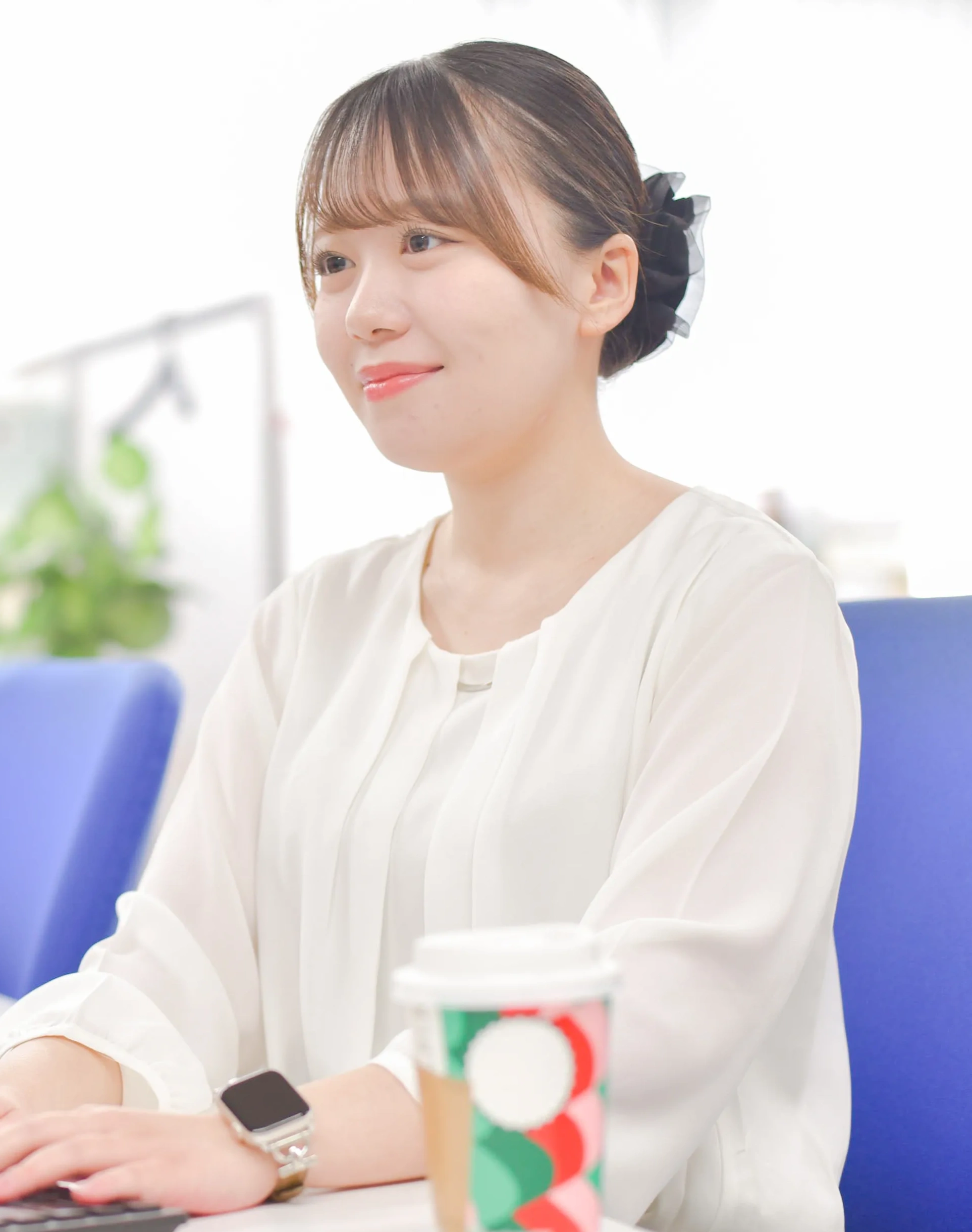 白いシャツを着た笑顔の女性社員